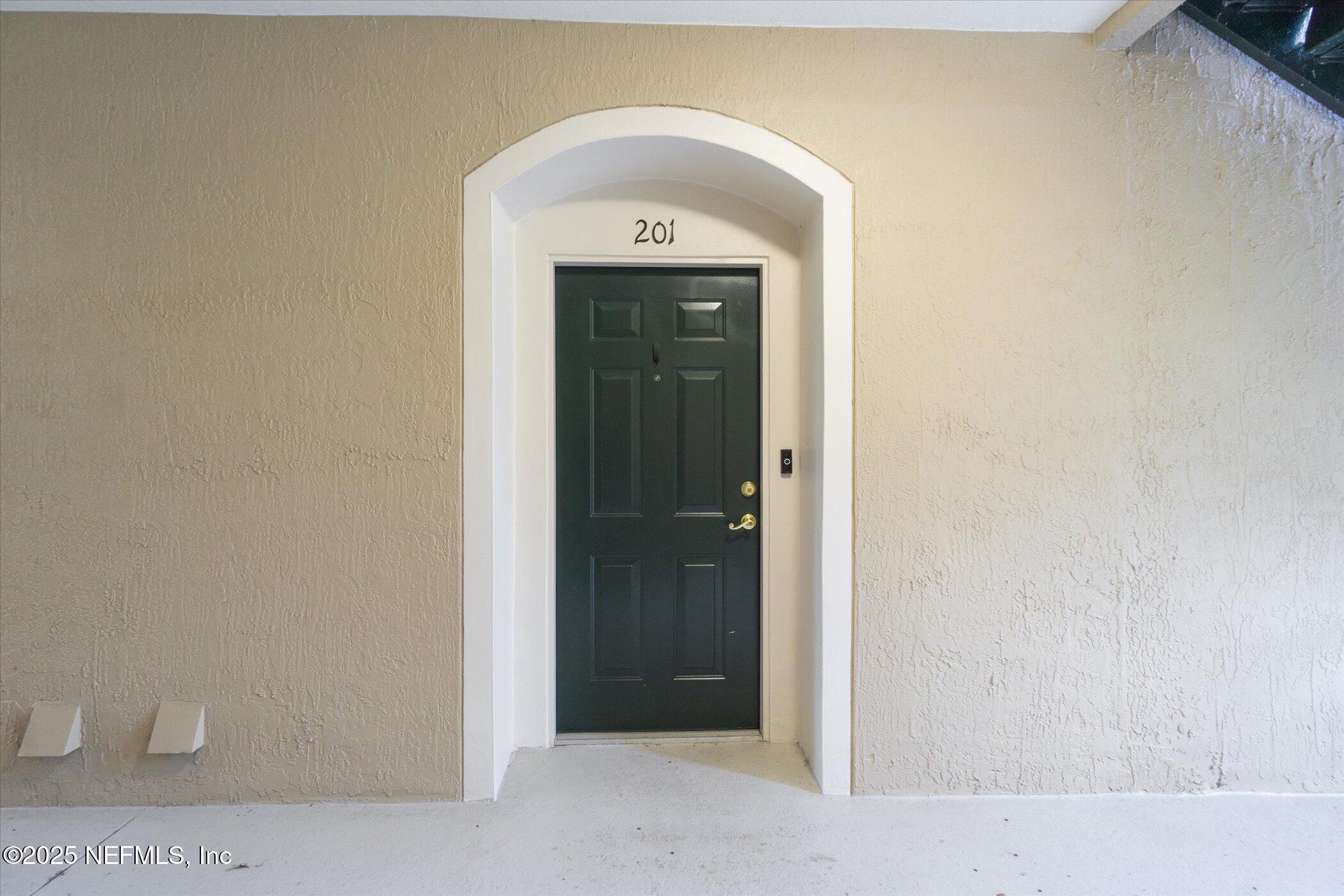 7990 Baymeadows Road East, Unit 201 Jacksonville, FL 32256 - Photo 3 of 43 a view of a hallway with wooden floor