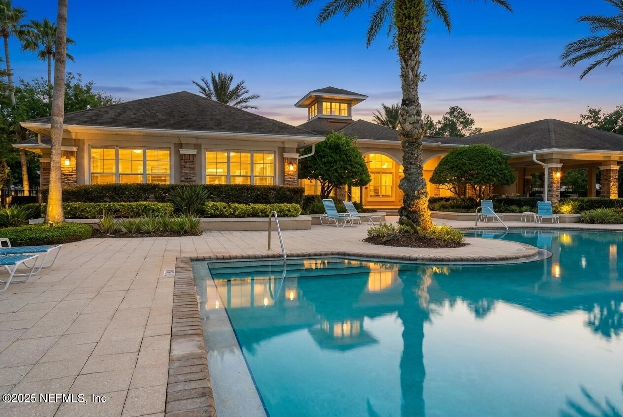 7990 Baymeadows Road East, Unit 201 Jacksonville, FL 32256 - Photo 35 of 43 a view of a swimming pool with a lawn chairs under an umbrella