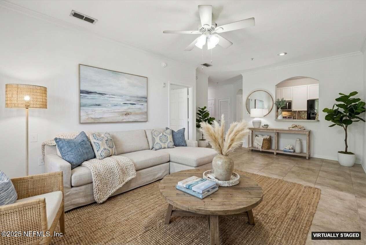 7990 Baymeadows Road East, Unit 201 Jacksonville, FL 32256 - Photo 4 of 43 a living room with furniture potted plant and a chandelier