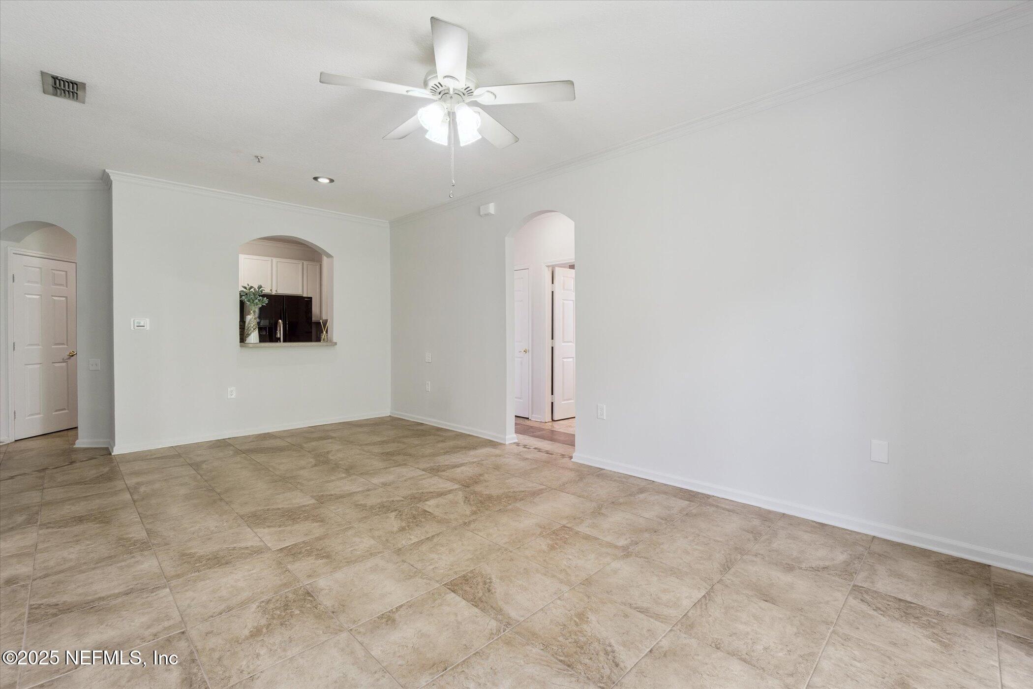 7990 Baymeadows Road East, Unit 201 Jacksonville, FL 32256 - Photo 7 of 43 a view of an empty room with a chandelier fan