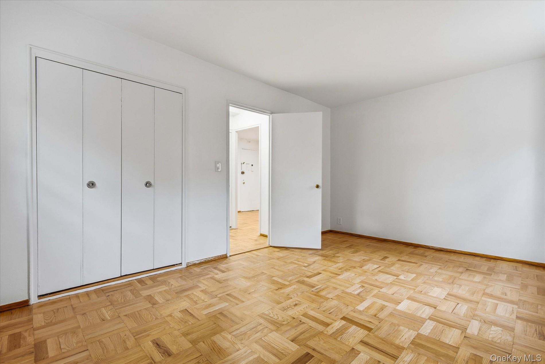 21-85 34th Avenue, Unit 2D Queens, NY 11106 - Photo 11 of 17 Unfurnished bedroom with a closet and baseboards