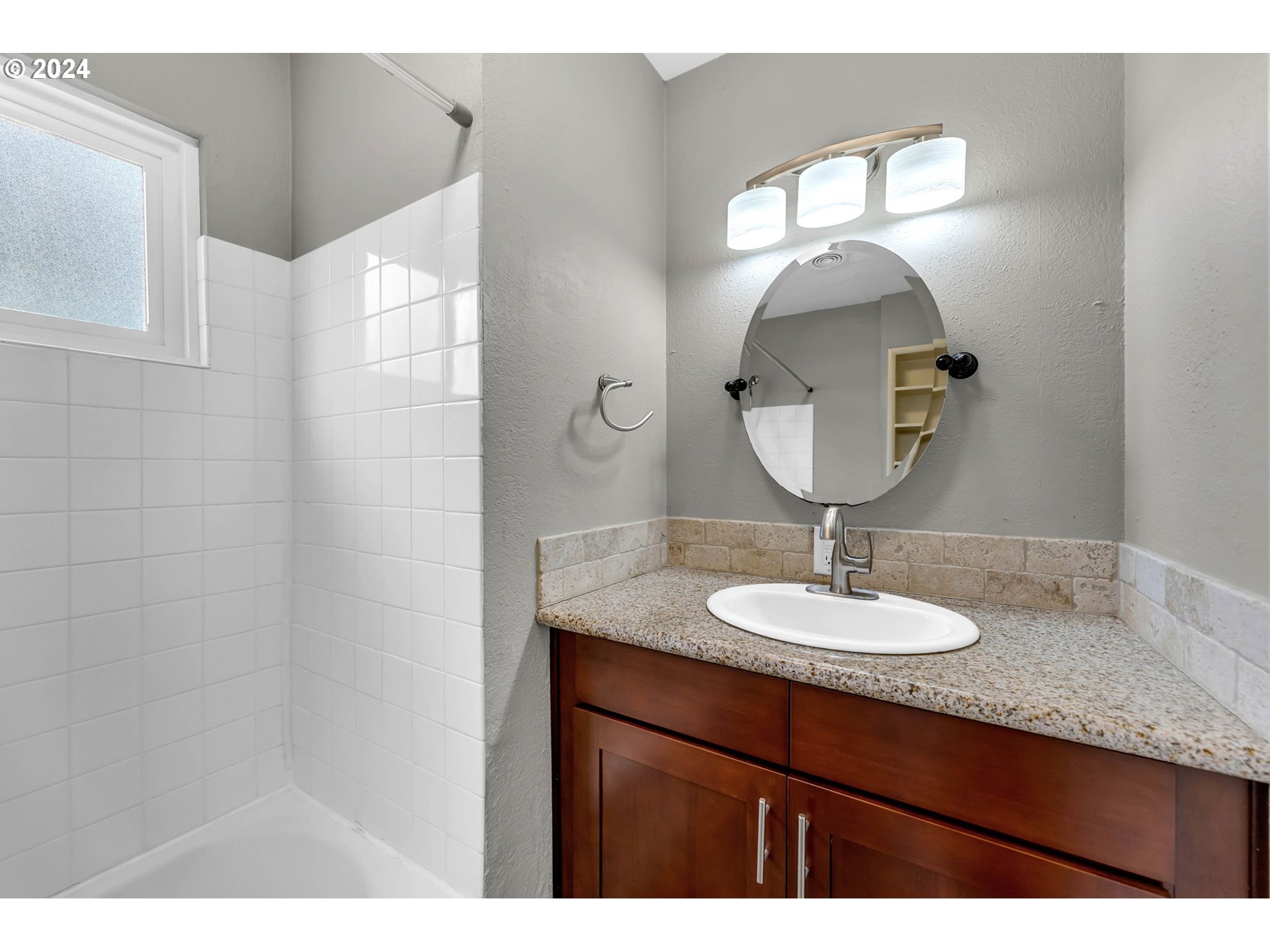 825 Northwest Greeley Street Camas, WA 98607 - Photo 16 of 27 a bathroom with a granite countertop sink a mirror and a shower