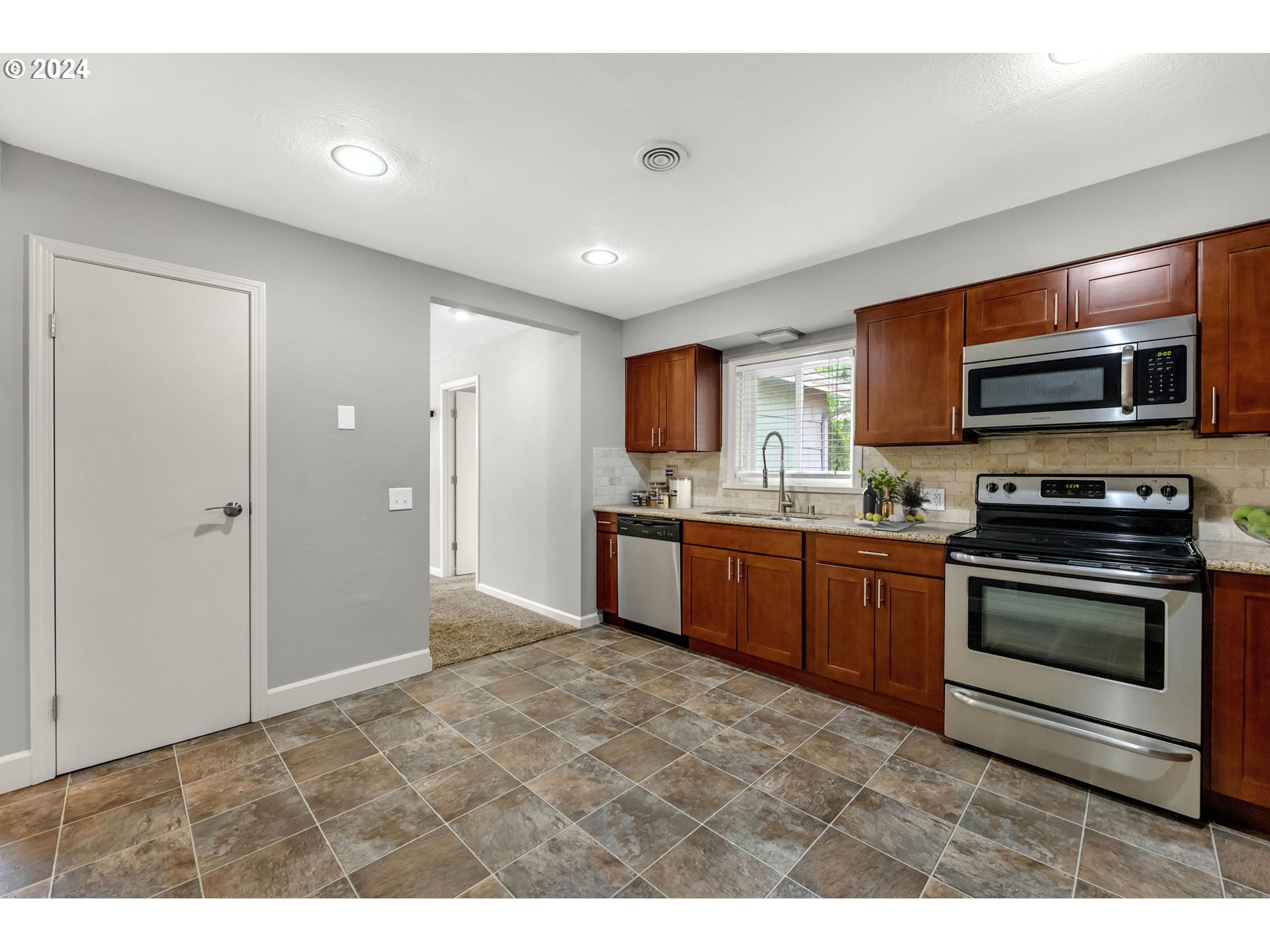 825 Northwest Greeley Street Camas, WA 98607 - Photo 10 of 27 a kitchen with stainless steel appliances granite countertop a stove a sink and a refrigerator
