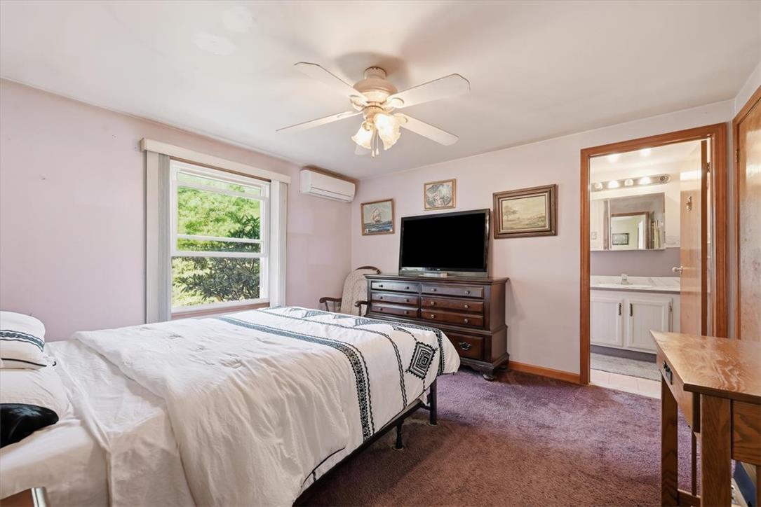 74 Swiss View Road Lehighton, PA 18235 - Photo 33 of 59 A comfortable bedroom features soft carpeting, a wide window, and access to an adjoining bathroom.