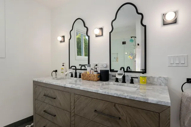 a bathroom with a double vanity sink and a mirror