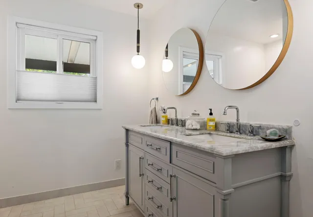 a bathroom with a granite countertop sink a mirror and a