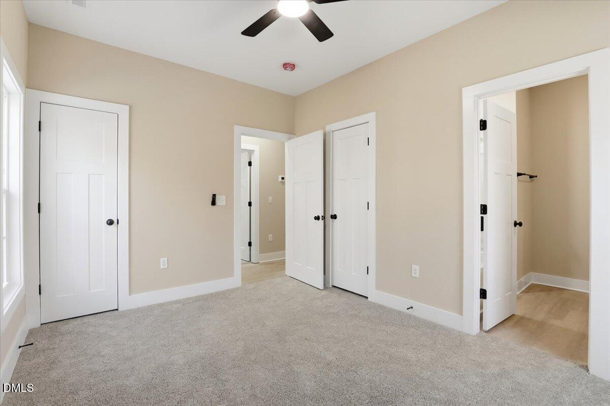 358 Natchez Trace Fuquay-Varina, NC 27526 - Photo 16 of 26 a view of a livingroom with a ceiling fan & entryway