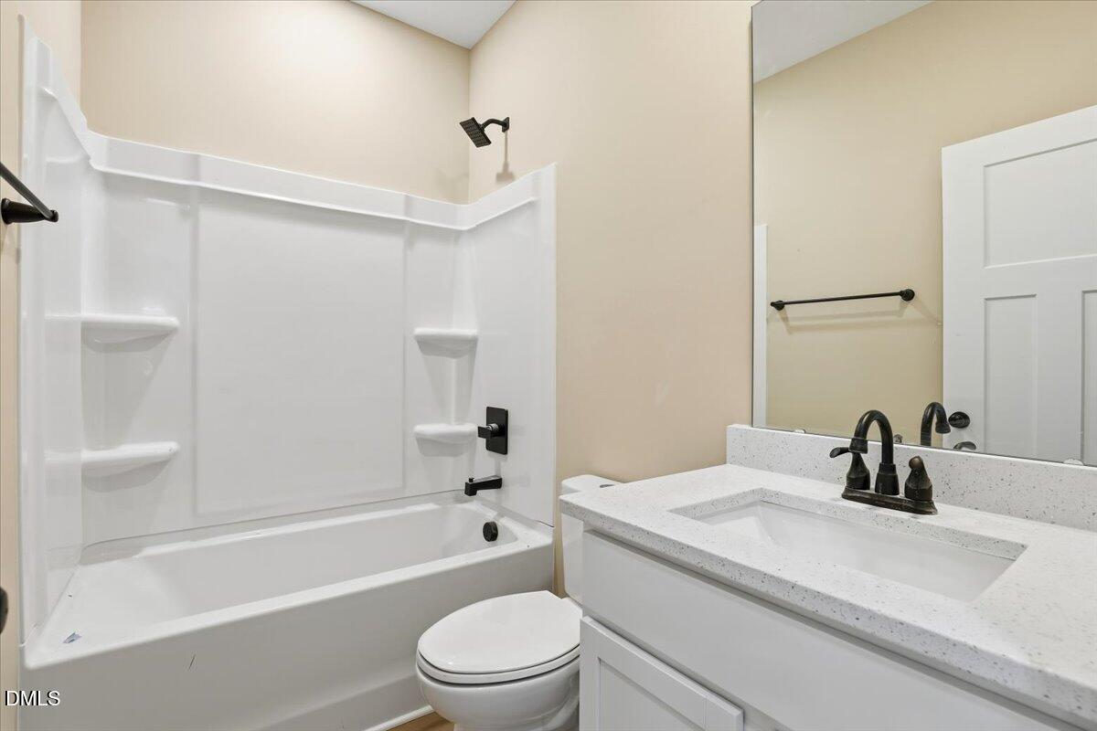 358 Natchez Trace Fuquay-Varina, NC 27526 - Photo 17 of 26 a bathroom with a granite countertop sink toilet and shower