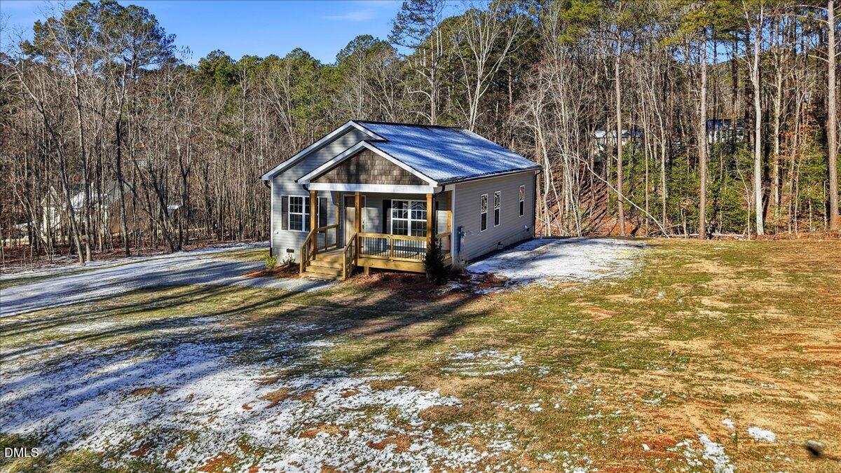 358 Natchez Trace Fuquay-Varina, NC 27526 - Photo 23 of 26 a view of a house with a large trees and wooden fence