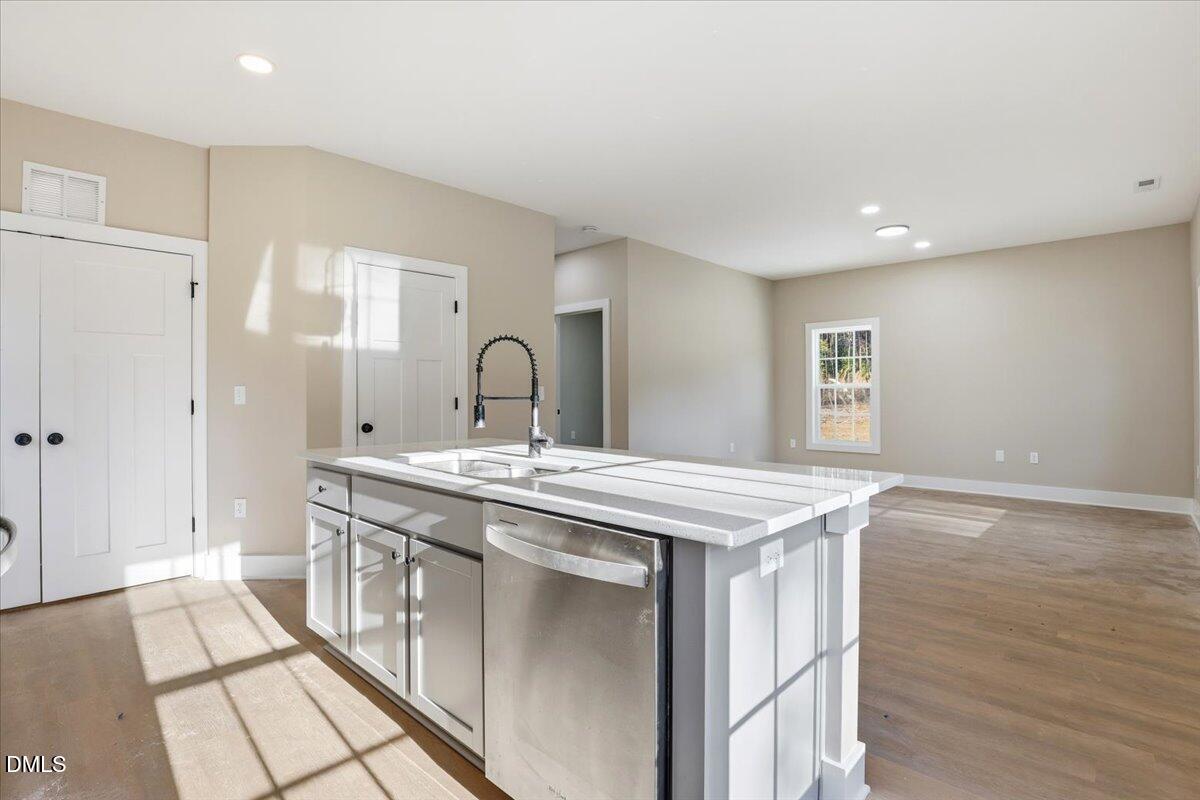 358 Natchez Trace Fuquay-Varina, NC 27526 - Photo 7 of 26 a kitchen with stainless steel appliances granite countertop a stove a sink and a refrigerator