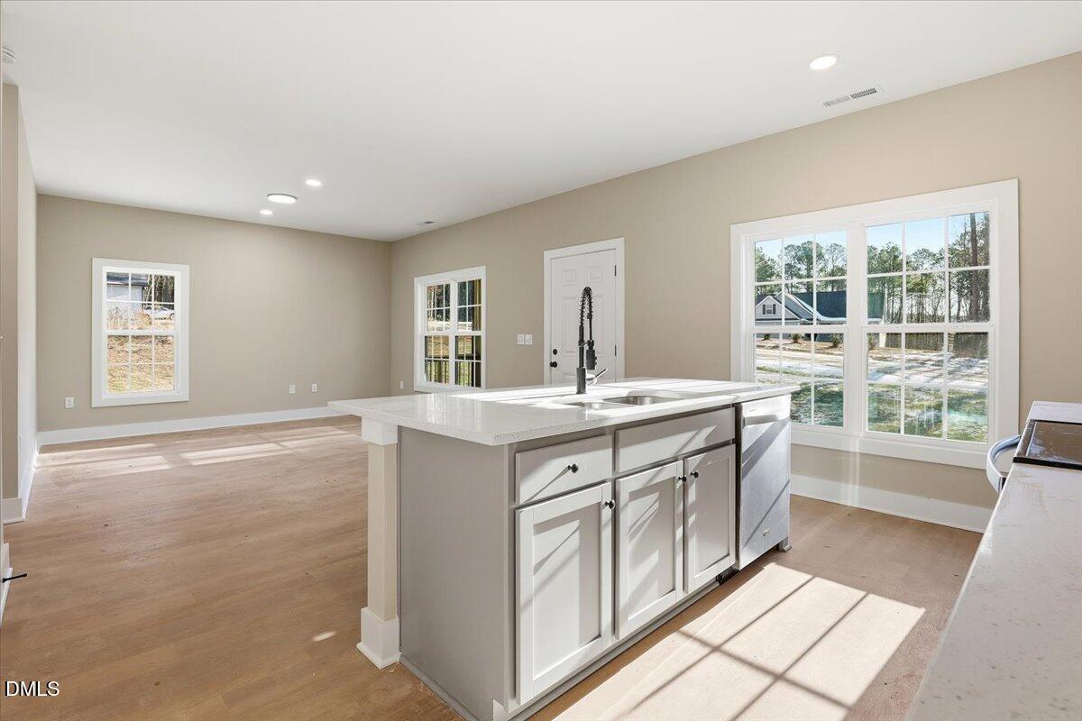 358 Natchez Trace Fuquay-Varina, NC 27526 - Photo 9 of 26 a bathroom with a double vanity sink a large mirror and next to a window