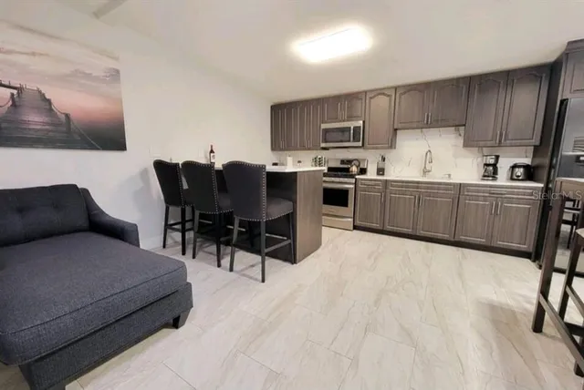 a bedroom with a bed and potted plant