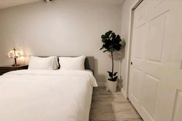 a view of a house with a yard and potted plants