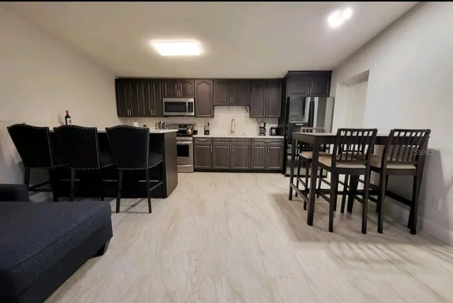 a view of a house with backyard and sitting area