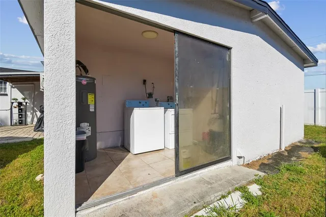 an aerial view of a house with a garden and lake view