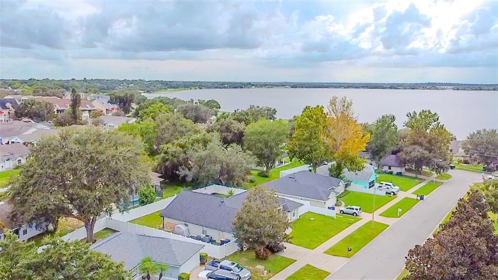 an aerial view of residential houses with outdoor space and street view
