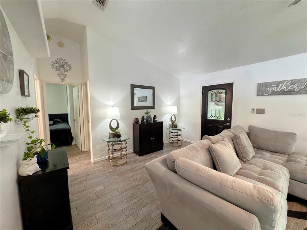 408 Raymond Street Minneola, FL 34715 - Photo 15 of 40 a living room with furniture and wooden floor