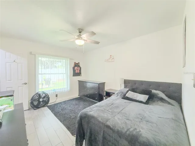 a bedroom with a large bed and a window