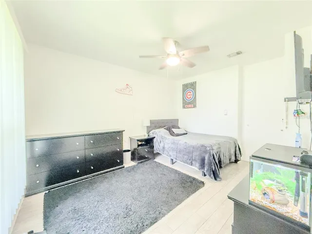 a spacious bedroom with a bed and a window