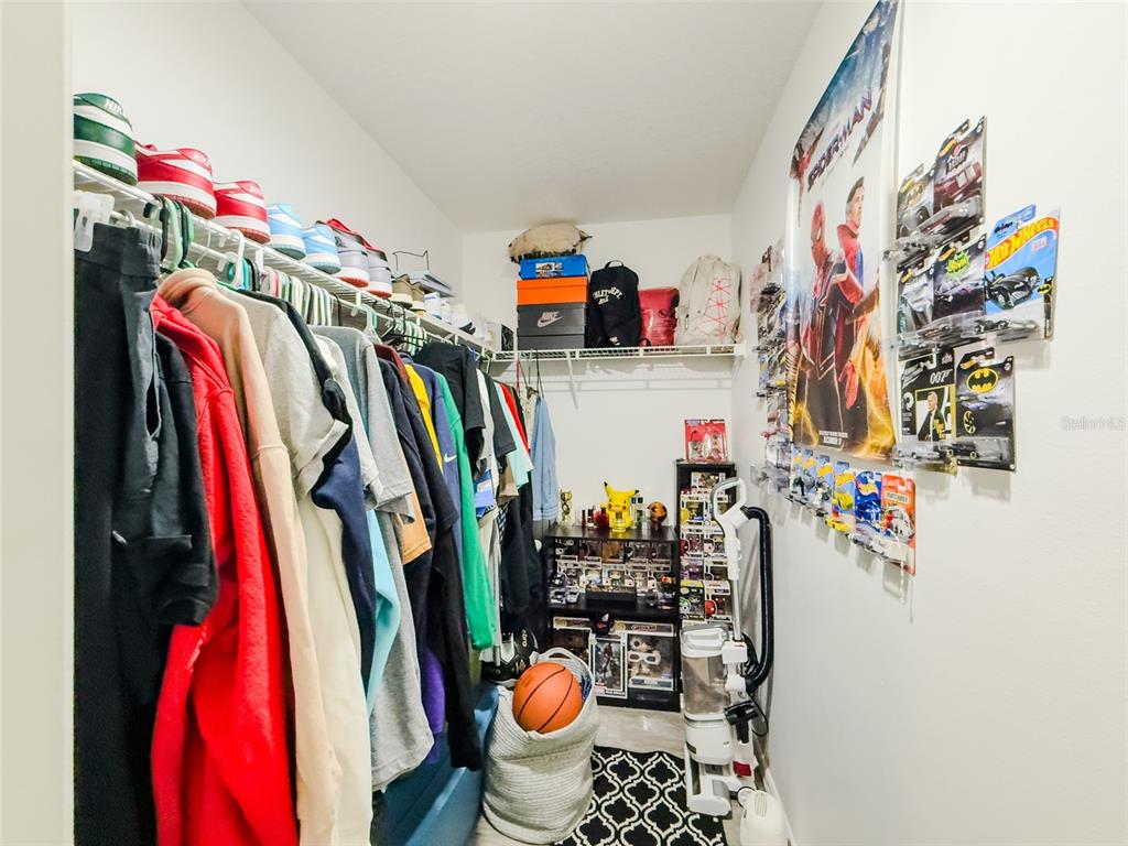 408 Raymond Street Minneola, FL 34715 - Photo 20 of 40 a view of walk in closet with clothes and shoes