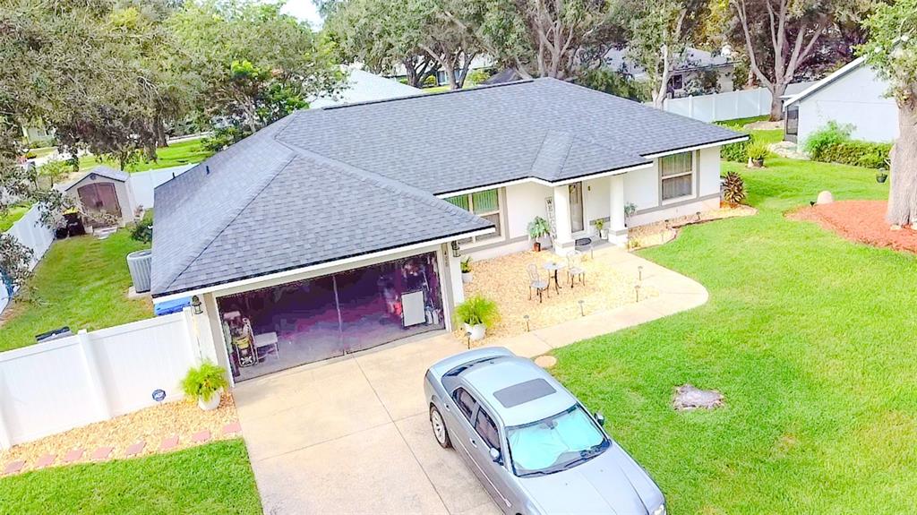 408 Raymond Street Minneola, FL 34715 - Photo 2 of 40 a aerial view of a house with table and chairs under an umbrella