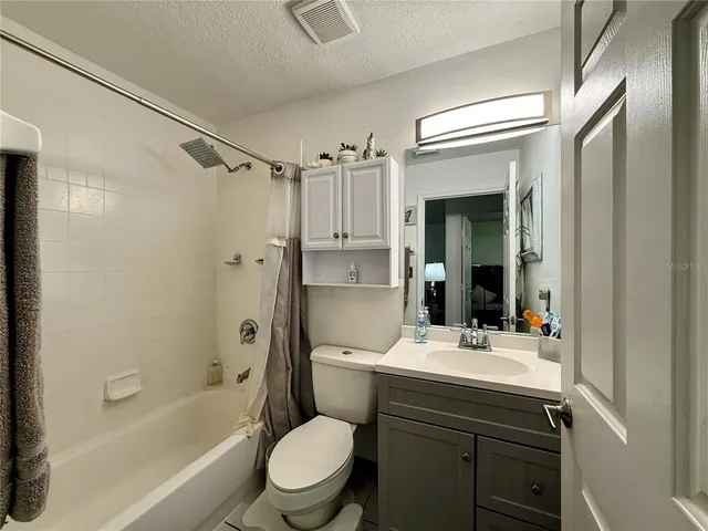 a bathroom with a sink toilet tub and shower