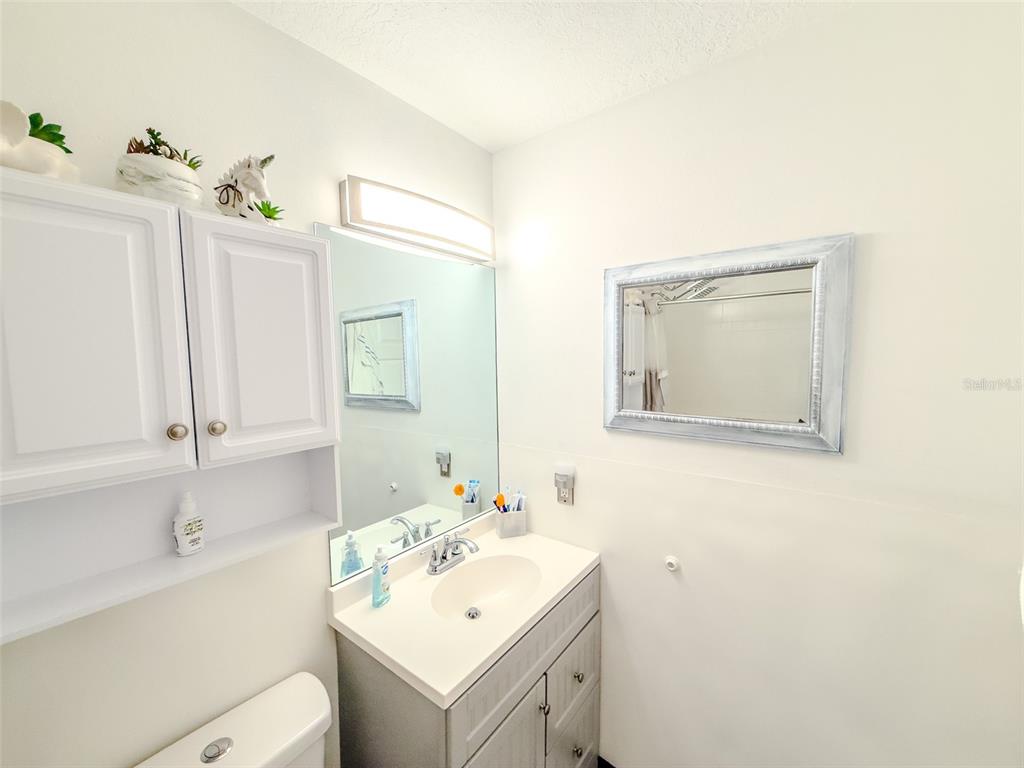 408 Raymond Street Minneola, FL 34715 - Photo 22 of 40 a bathroom with a sink toilet and mirror