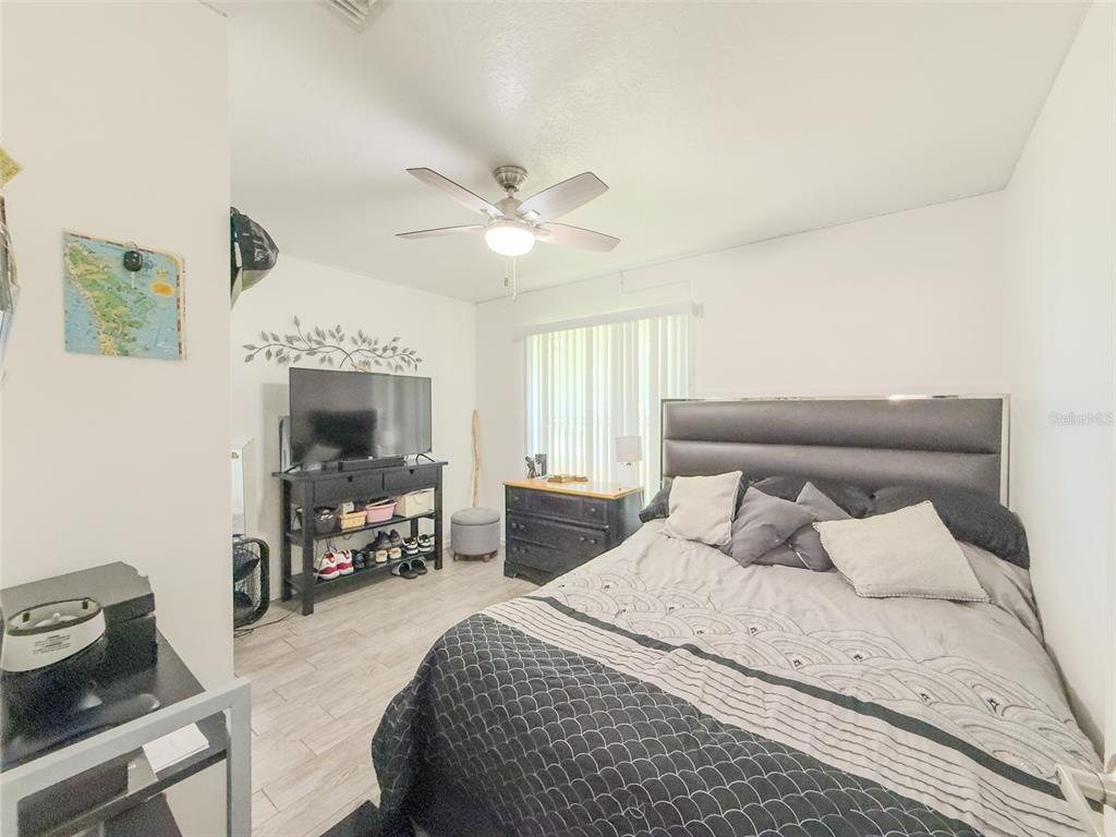 408 Raymond Street Minneola, FL 34715 - Photo 23 of 40 a bedroom with a large bed and a tv