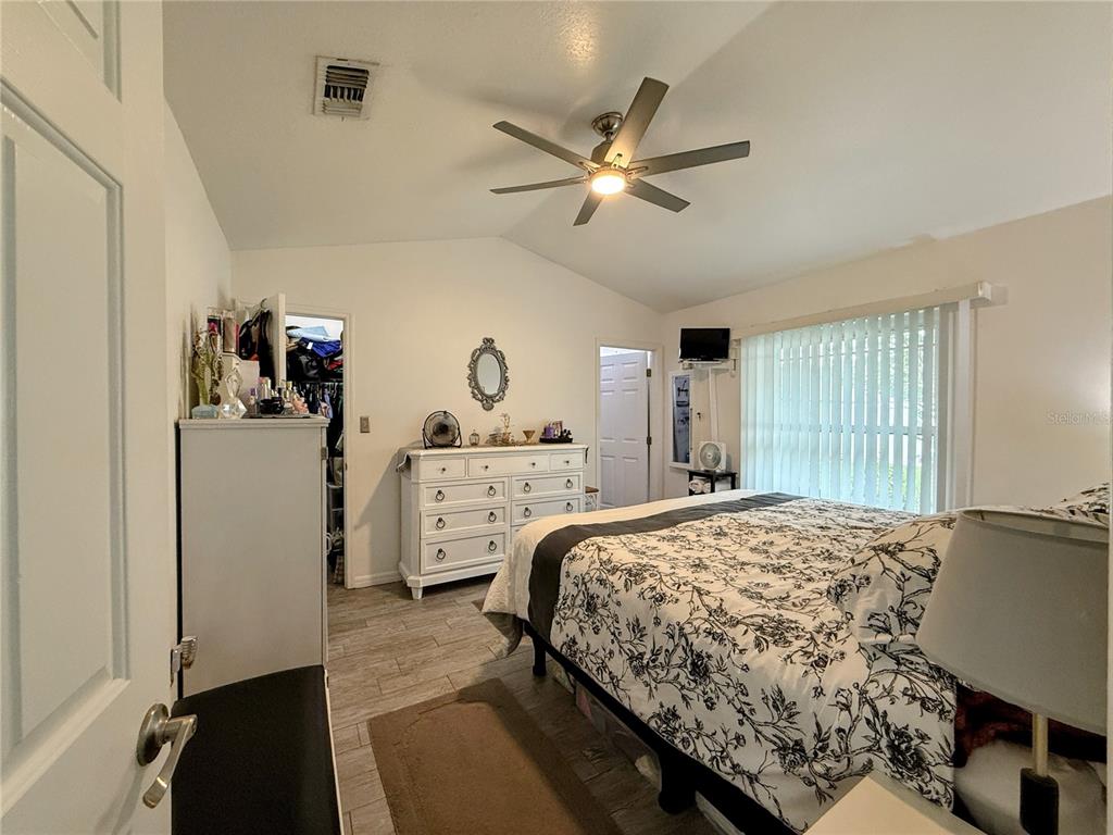 408 Raymond Street Minneola, FL 34715 - Photo 25 of 40 a bedroom with a bed and a dresser