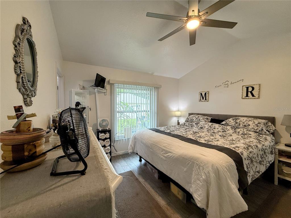 408 Raymond Street Minneola, FL 34715 - Photo 26 of 40 a bedroom with a bed a desk and chair