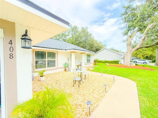 a house view with swimming pool and next to a yard
