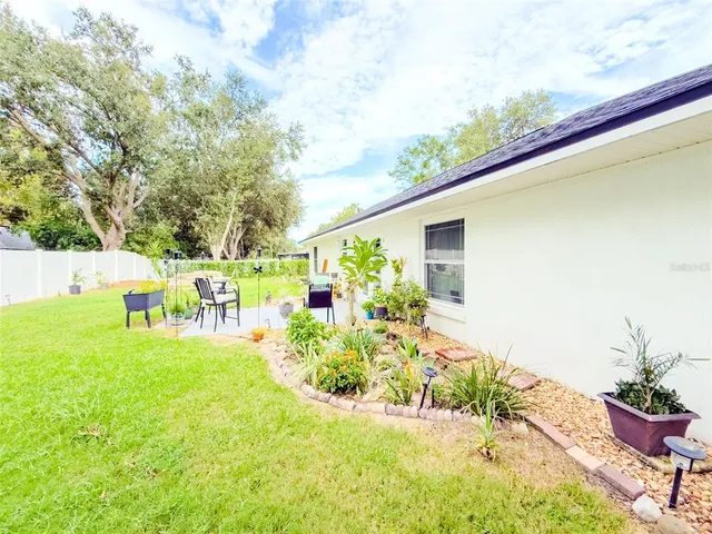 a front view of a house with a yard and fountain