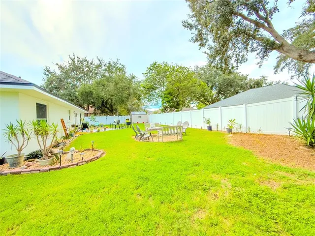 a view of a backyard with plants and a patio