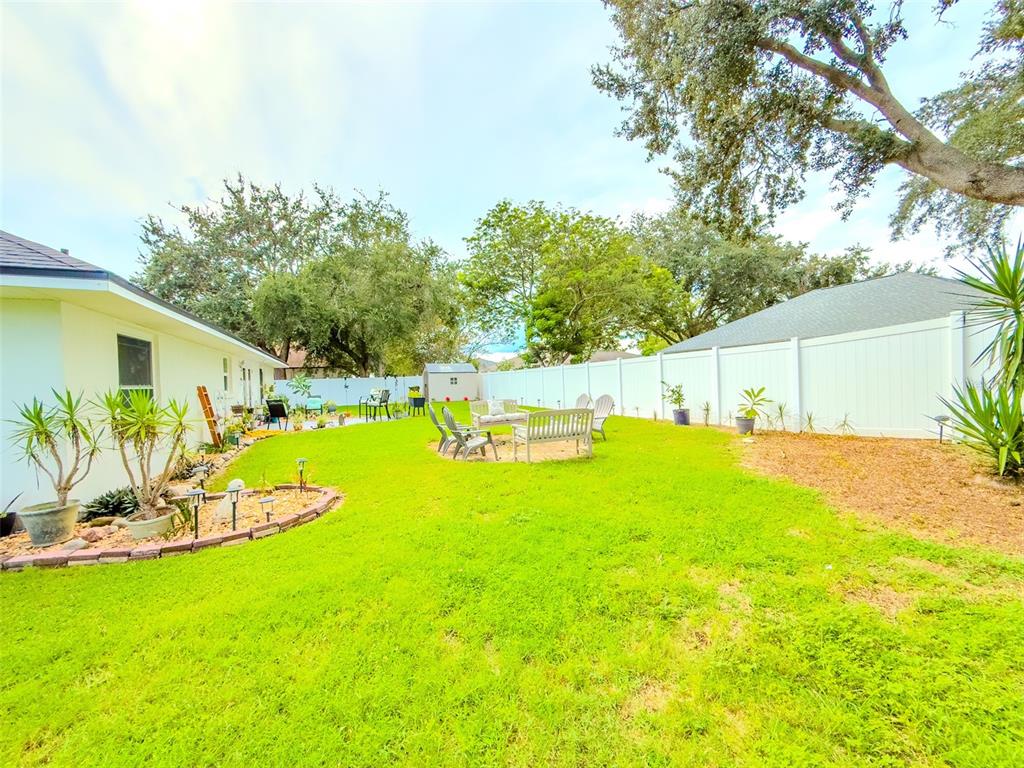 408 Raymond Street Minneola, FL 34715 - Photo 36 of 40 a view of a backyard with plants and a patio
