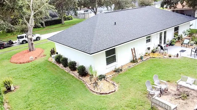 a backyard of a house with table and chairs