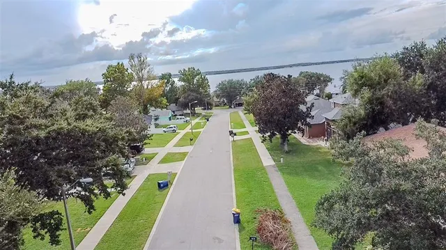 a view of yard with swimming pool and lawn chairs