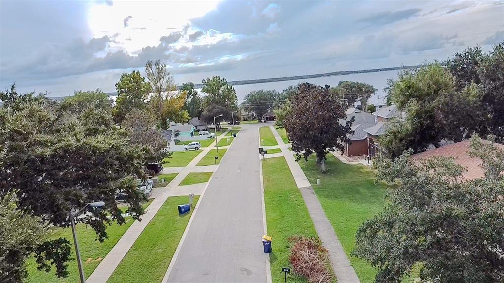 408 Raymond Street Minneola, FL 34715 - Photo 40 of 40 a view of yard with swimming pool and lawn chairs