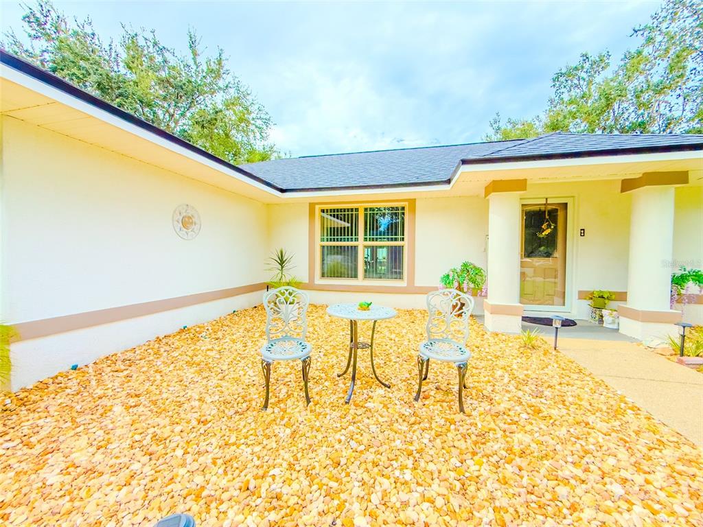 408 Raymond Street Minneola, FL 34715 - Photo 4 of 40 a view of an chairs and table in th patio