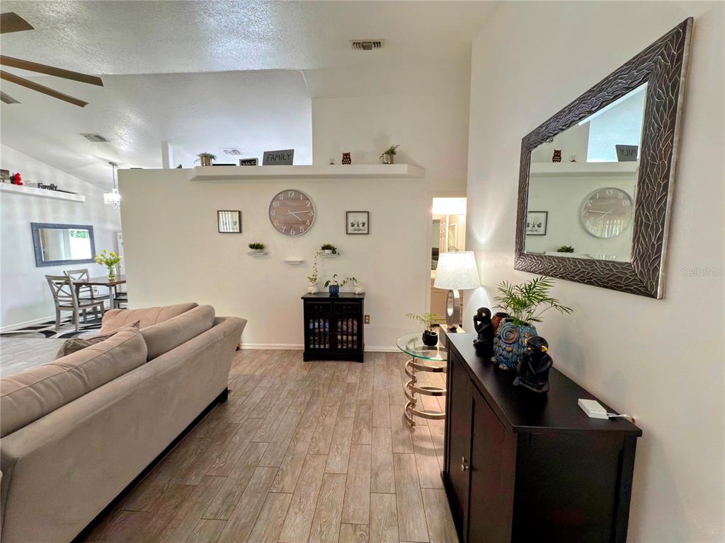 408 Raymond Street Minneola, FL 34715 - Photo 5 of 40 a living room with furniture and a flat screen tv