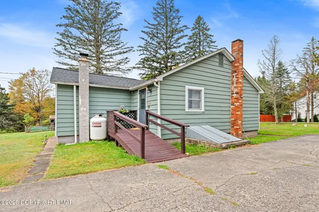 a backyard of a house with outdoor seating