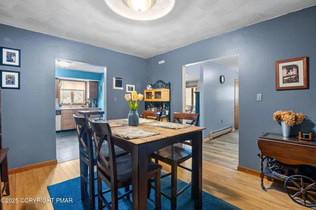 a living room with furniture and a book shelf