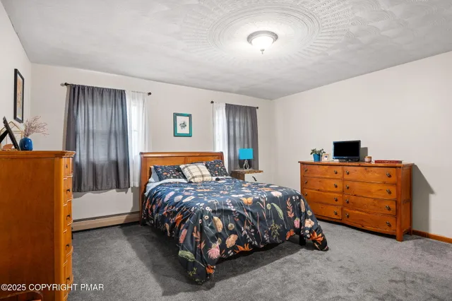 a white toilet sitting next to a white sink and a shower curtain