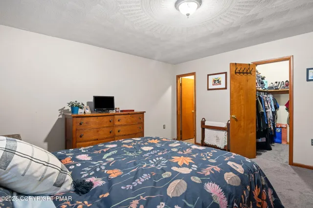 a bedroom with a bed and chair