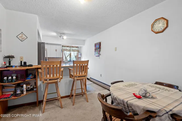 a kitchen with a refrigerator and white cabinets