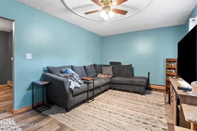 a living room with furniture and a book shelf