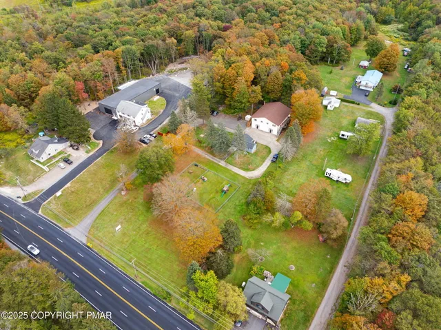a kitchen with stainless steel appliances granite countertop a stove a refrigerator a sink dishwasher a dining table and chairs with wooden floor