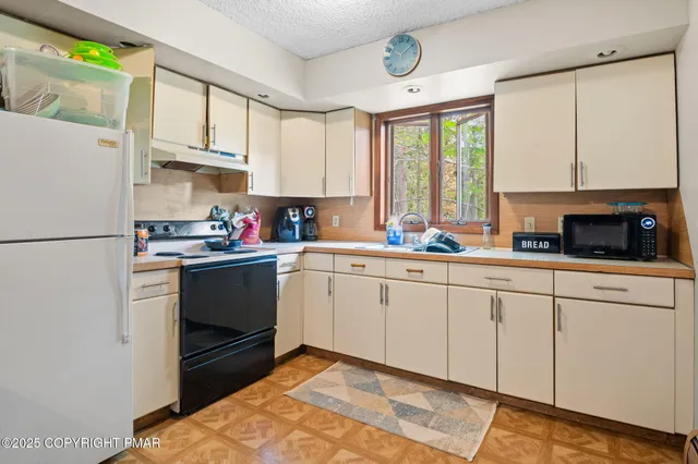an outdoor space with lots of furniture and white walls