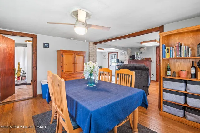 a living room with furniture large window and potted plants