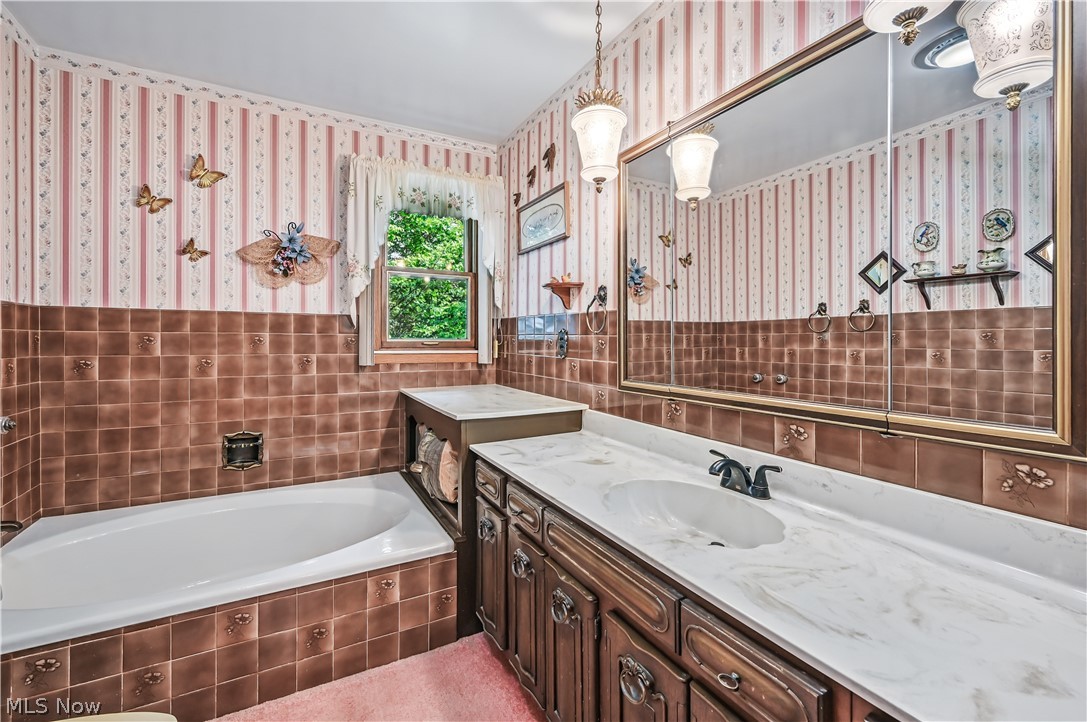 2717 Niles Vienna Road Niles, OH 44446 - Photo 33 of 50 Bathroom with tile walls, wallpapered walls, vanity, and a garden tub