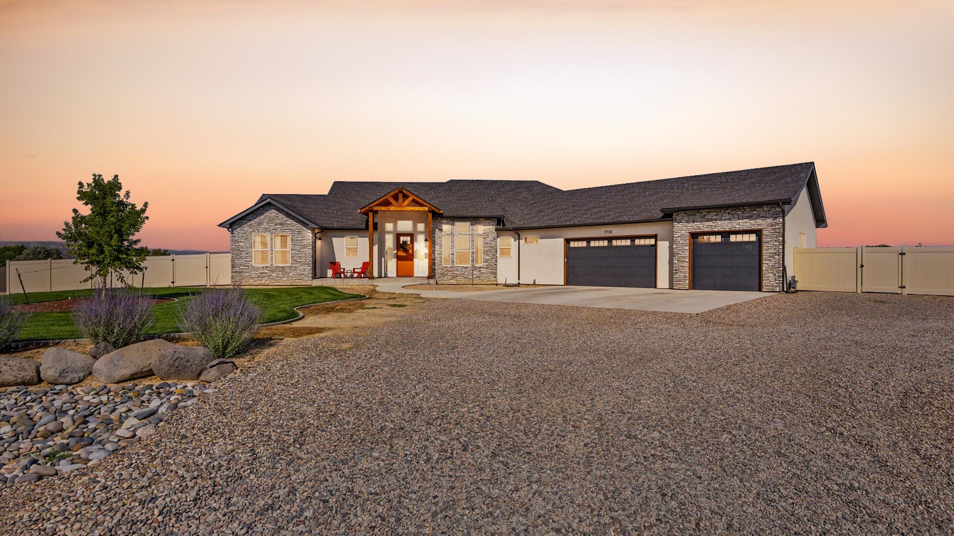 1730 Stremel Creek Fruita, CO 81521 - Photo 2 of 42 a front view of a house with a yard